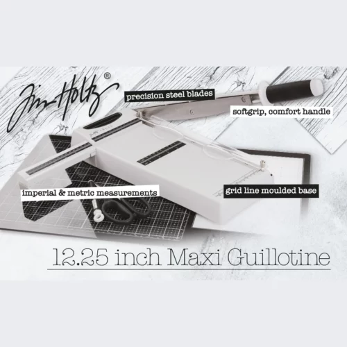 A promotional image for the Tim Holtz Maxi Guillotine Comfort Paper Trimmer. The trimmer has a light grey plastic base and a guillotine arm with a black kushgrip handle for comfort. The Tim Holtz logo is shown in the image.