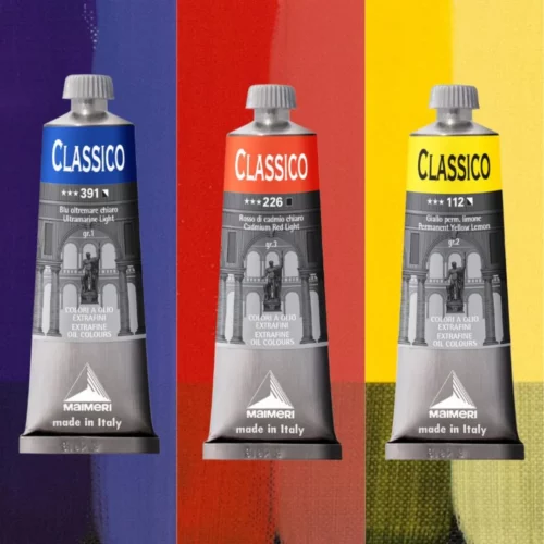Three tubes of Maimeri Classico Oil Paint are seen next to each other in the center of teh frame. Behind each tube is a colour block which indicates the colour of the tube. Blue on the left, red in the middle and yellow on the right. The tubes are standing vertically and are front facing. The tubes are metal with a label around the body of each tube with text and branding.