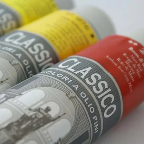 A close up of 3 tubes of Maimeri Classico Oil Paint that are laying diagonally across the frame. You can only see part of the tubes as they are cut off by the frame. The tubes are silver metal and have a label around the body of each tube. Each label has a colour band that indicates the colour of the tube.
