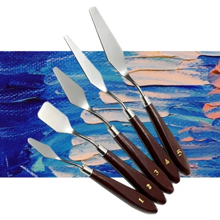 The loose knives from the Prime Art Metal Palette Knife Set are shown staggered, in a fan shape across the center of the frame. The knives have wooden handles with gold numbers printed on the handles. Each knife has a different shaped metal blade. and on a textured blue and pink background.