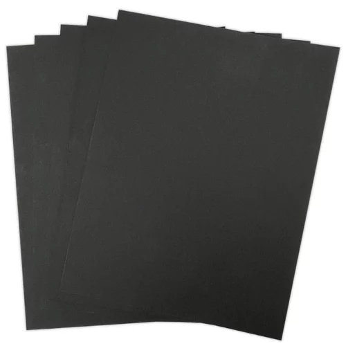 The 5 sheets of black paper from the pack of Tim Holtz Distress Heavystock Black are shown loose, fanned out in the center of the page. The sheets are black and are on a white background.