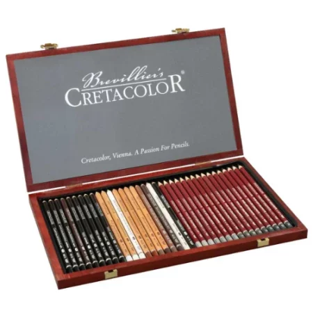 wooden box in the center of the image. the box is open and on the inside of the top are the words cretacolor. on the bottom inside of the box are all the pencils lad out in a row. the black pencils are on the left hand side of the image, the middle is while and brown and the far right is red. the box is elegant looking.