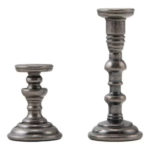 A close up of the 2 candlesticks in a pack of Tim Holtz Idea-ology The Manor. The candlestick on the left is smaller than the one on the right. They are ornate, metal candlestick and are center of the frame and on a white background.