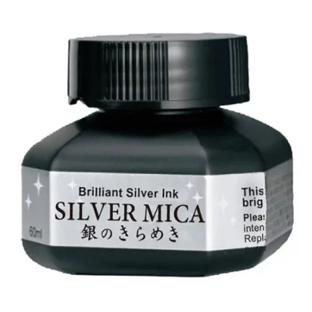 A single bottle of Silver Kuretake Mica Ink can be seen in the center of the frame. The bottle is frosted plastic and has a black plastic screw on lid. There is a label around the body of the bottle with the product name. You can see the coloured ink through the bottle. The image is on a white background.