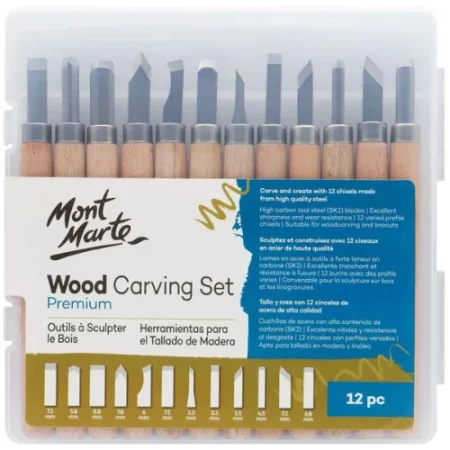 The back of the Mont Marte Wood Carving Set is shown in the center of the frame. The 12 tools are encased in a hard, clear plastic case. You can see the tools lined up next to each other vertically in the set. The tools have wooden handles and metal blades of different shapes. There is a label on the plastic box with the Mont Marte logo and other text describing the contents of the set. On a white background.