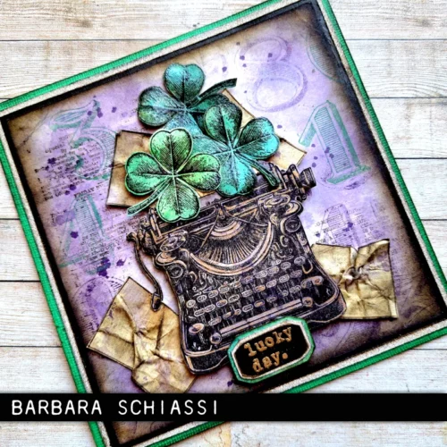 A card that was made with the Curiosity Shop Tim Holtz Stamp Set is shown in the frame. The card is vintage themed and there is a typewriter with some 4 leaf clovers on the front.