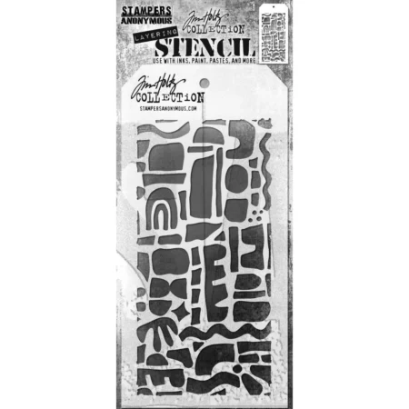 A single Cutout Shapes 1 Tim Holtz Layering Stencil is seen in the center of the frame in it's packaging. The packaging has a printed backing board with a clear plastic that holsd the stencil to the backing board. The backing is printed in grey and has some text at the top of the packaging describing the contents and includes the Tim Holtz logo. You can see the stencil through the clear packaging. The stencil is plastic and tag shaped and the design is cut out from the body of the tag shaped stencil. The image is center of the frame and on a white background.