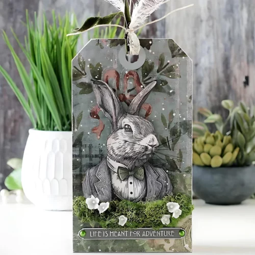 A tag that was made using the Mr Rabbit Tim Holtz Stamp Set is shown in the frame.