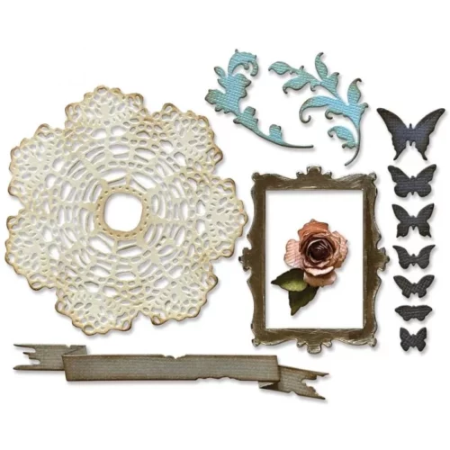 There is a set of Vault Boutique by Tim Holtz Thinlits Die shown in the center of the frame. The images from the front of the packaging are shown in this frame. They are the die cut pieces that form the shapes of the die. They are made from coloured pieces of cardstock and are center of the frame and on a white background.