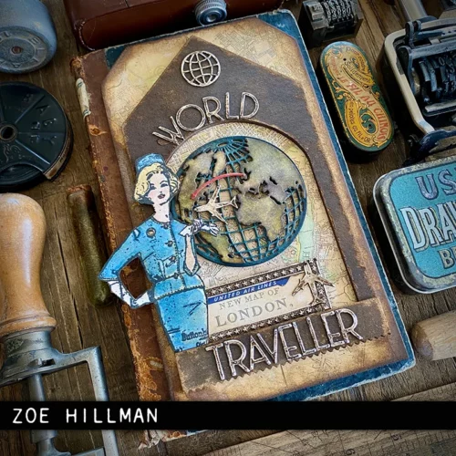 An altered art project panel is shown in the frame and was made using the Vault World Travel by Tim Holtz Thinlits Die Set. The panel is vintage in style and has a picture of a woman that has been stamped and coloured, standing next to a world map, with the words 'world traveller'.