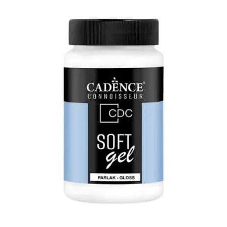 There is a single bottle of Cadence Connoisseur Soft Gel Gloss shown standing vertically in the center of the frame. The bottle is clear plastic and has a black screw on lid. There is a label around the body of the bottle that is coloured with blue and black and has text describing the contents of the bottle and has the brand name. The gel inside the bottle is white and can be seen through the clear plastic. The image is center of the frame and on a white background.