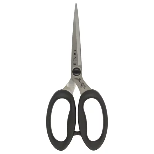 A single pair of Tim Holtz Haberdashery Scissors can be seen laying vertically in the center of the frame. The scissors have a black plastic handle and a metal blade. On a white background.