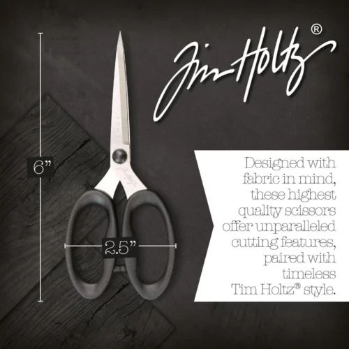 A promotional image for Tim Holtz Haberdashery Scissors. The scissors are shown laying on a faux wooden background, with the measurements of the scissors shown in the image. The Tim Holtz logo is seen in the top right hand corner of the frame.