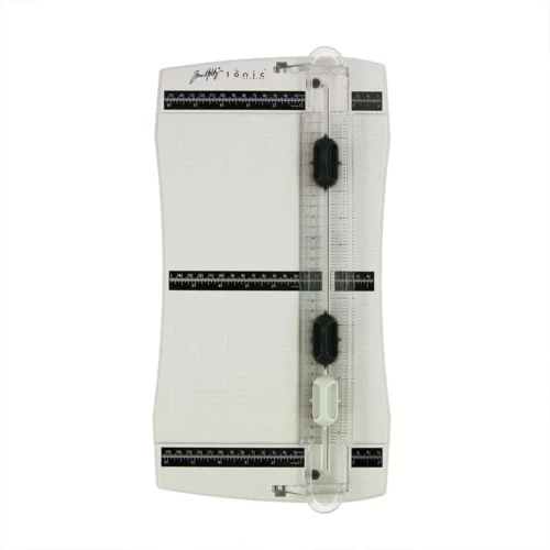 The Tim Holtz Precision Trimmer has a light grey plastic base with grid marks debossed on the surface. It has a imperial and metric rulers with an extendable base and a geared rotary trimmer arm. The trimmer is rectangular in shape and is shown in the frame at a slight angle on a white background.
