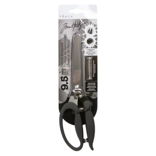 A single pair of Tim Holtz Recoil Scissors in their packaging can be seen vertically in the center of the frame. The scissors have a black plastic handle and a metal blade with a spring between the handles. The packaging has a cardboard backing that is attached to the scissors. On a white background.