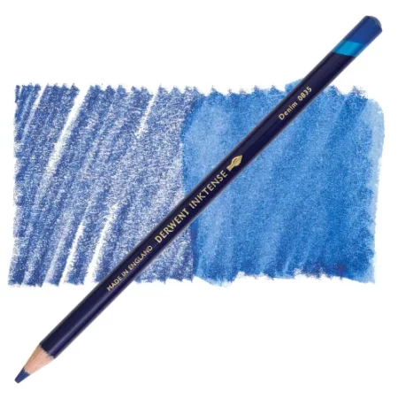 A single Denim Derwent Inktense Colour Pencil is shown diagonally across the center of the frame. The pencil is pointing with it's lead facing towards the bottom left hand corner. The barrel of the pencil is blue and the end of the pencil is colour dipped to match the colour of the lead for easy identification. There is text down the barrel of the pencil with the colour name and brand name. There is a colour swatch of the pencil in the background, that runs horizontally across the center of the frame. The image is center of the frame and on a white background