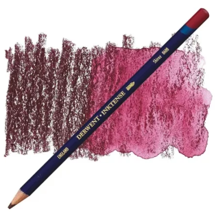 A single Shiraz Derwent Inktense Colour Pencil is shown diagonally across the center of the frame. The pencil is pointing with it's lead facing towards the bottom left hand corner. The barrel of the pencil is blue and the end of the pencil is colour dipped to match the colour of the lead for easy identification. There is text down the barrel of the pencil with the colour name and brand name. There is a colour swatch of the pencil in the background, that runs horizontally across the center of the frame. The image is center of the frame and on a white background