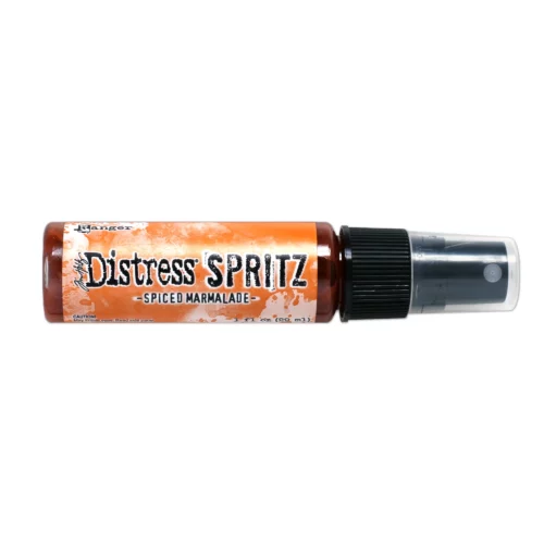 A single bottle of Spiced Marmalade Tim Holtz Distress Spritz is shown laying horizontally in the center of the frame. The bottle is a clear plastic with a black plastic spray top and a clear plastic lid. There is a coloured label around the body of the bottle that indicates the colour of the ink. The Distress Logo and product details are printed on the label. The image is center of the frame and on a white background.