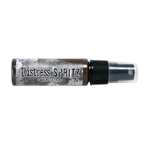 A single bottle of Walnut Stain Tim Holtz Distress Spritz is shown laying horizontally in the center of the frame. The bottle is a clear plastic with a black plastic spray top and a clear plastic lid. There is a coloured label around the body of the bottle that indicates the colour of the ink. The Distress Logo and product details are printed on the label. The image is center of the frame and on a white background.