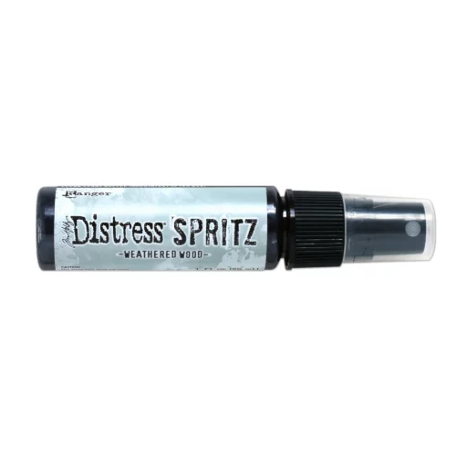 A single bottle of Weathered Wood Tim Holtz Distress Spritz is shown laying horizontally in the center of the frame. The bottle is a clear plastic with a black plastic spray top and a clear plastic lid. There is a coloured label around the body of the bottle that indicates the colour of the ink. The Distress Logo and product details are printed on the label. The image is center of the frame and on a white background.