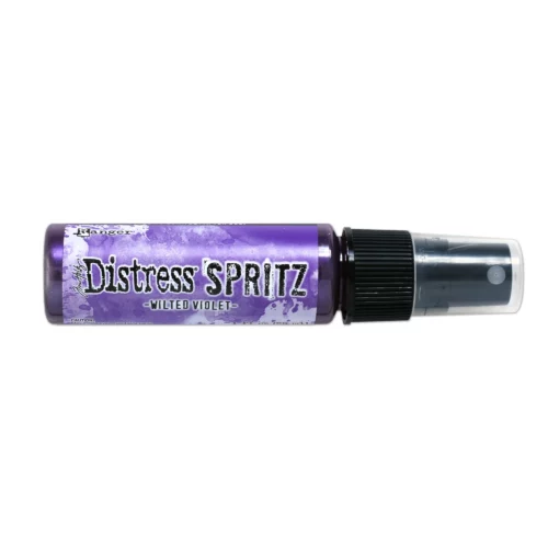 A single bottle of Wilted Violet Tim Holtz Distress Spritz is shown laying horizontally in the center of the frame. The bottle is a clear plastic with a black plastic spray top and a clear plastic lid. There is a coloured label around the body of the bottle that indicates the colour of the ink. The Distress Logo and product details are printed on the label. The image is center of the frame and on a white background.