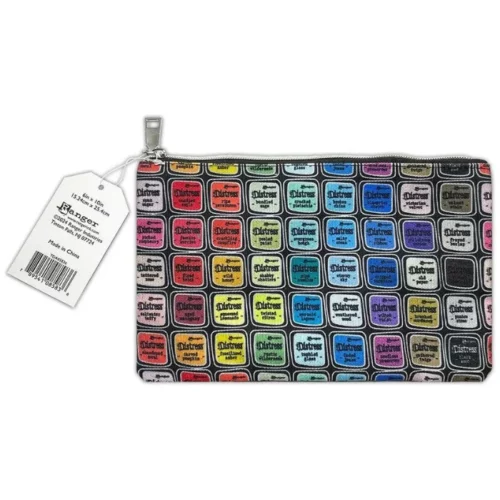 A Tim Holtz Distress Zipper Bag Medium is shown diagonally in the center of the frame. The bag is made of a printed fabric, adorned with colorful artwork from the complete Distress colour palette. The bag has a Distress tag attached to it and it has a metal zipper. On a white background.