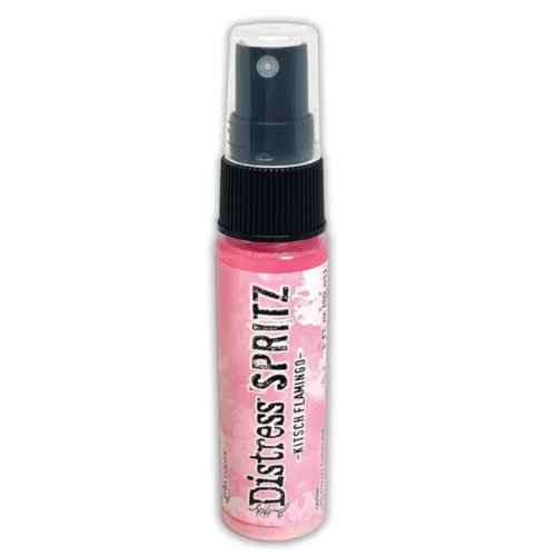 A single bottle of Kitsch Flamingo Tim Holtz Distress Spritz is shown standing vertically in the center of the frame. The bottle is a clear plastic with a black plastic spray top and a clear plastic lid. There is a coloured label around the body of the bottle that indicates the colour of the ink. The Distress Logo and product details are printed on the label. The image is center of the frame and on a white background.