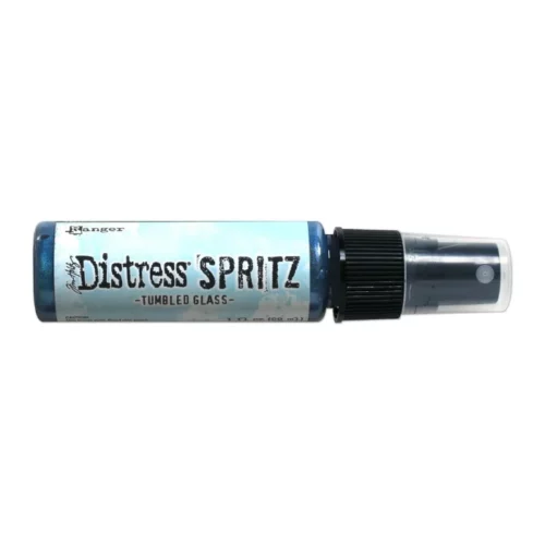 A single bottle of Tumbled Glass Tim Holtz Distress Spritz is shown laying horizontally in the center of the frame. The bottle is a clear plastic with a black plastic spray top and a clear plastic lid. There is a coloured label around the body of the bottle that indicates the colour of the ink. The Distress Logo and product details are printed on the label. The image is center of the frame and on a white background.